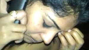 Randi in a hotel room, talking on the phone and smoking.