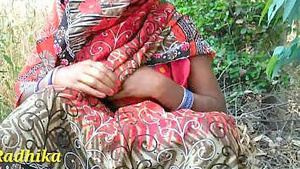 A married woman from India exposes her breasts and vagina in a field.
