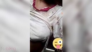 An Indian woman shows her breasts on command from a friend.