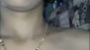 A married Indian woman shows off her augmentations and private parts in a porn video.