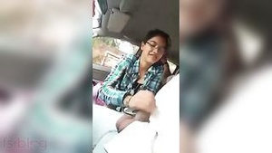 Beautiful Indian woman giving oral sex to her smiling boyfriend in the car.