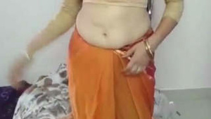 Big-breasted Indian woman with her husband in a hardcore scene.