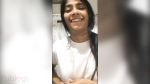 A young woman exposes her breasts and takes provocative selfies.