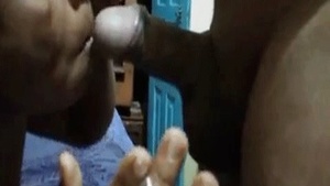 A mature sex worker free induced while giving a blowjob to a man who also has a cigarette.