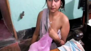 A Indian woman is nude in front of her male friend.