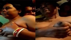 Here is a video of a mature village wife showing off her big boobs.