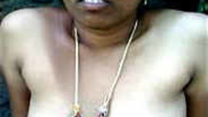 An aunt exposes her charms outside in the open air.