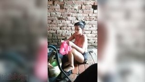 Home made video of a rustic Indian girl washing up in the river.